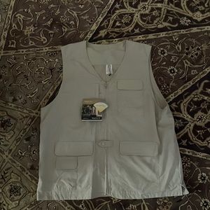 Magellan’s vest for hiking or fishing. 100% nylon. Lots of pockets. Cream color